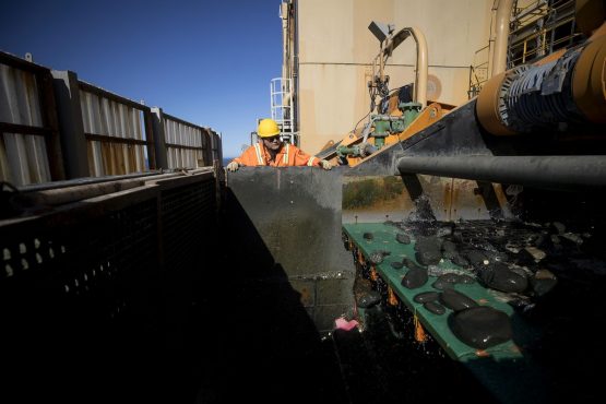 A high pressure spray cleans discarded non-diamond bearing gravel before being returned to the ocean from the Mafuta mining vessel. Picture: Simon Dawson/Bloomberg