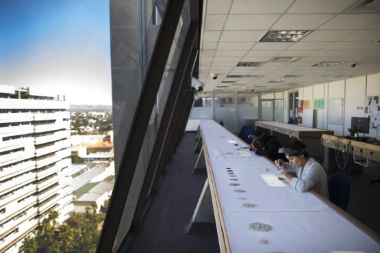 Employees grade rough diamonds using daylight to illuminate the gems at the Namibian Diamond Trading Co. processing and valuation center in Windhoek. Picture: Simon Dawson/Bloomberg