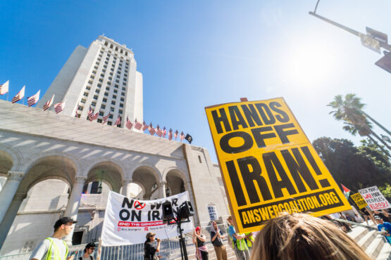A demonstrator holds a sign reading 